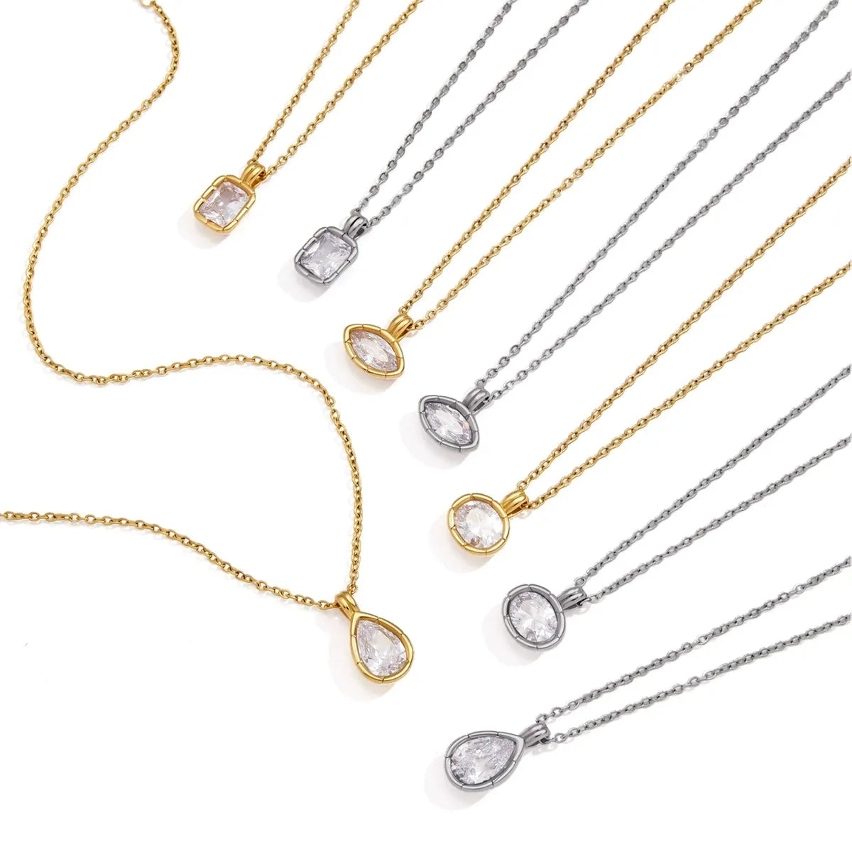 Assorted clear stone pendant necklaces arranged on a white background