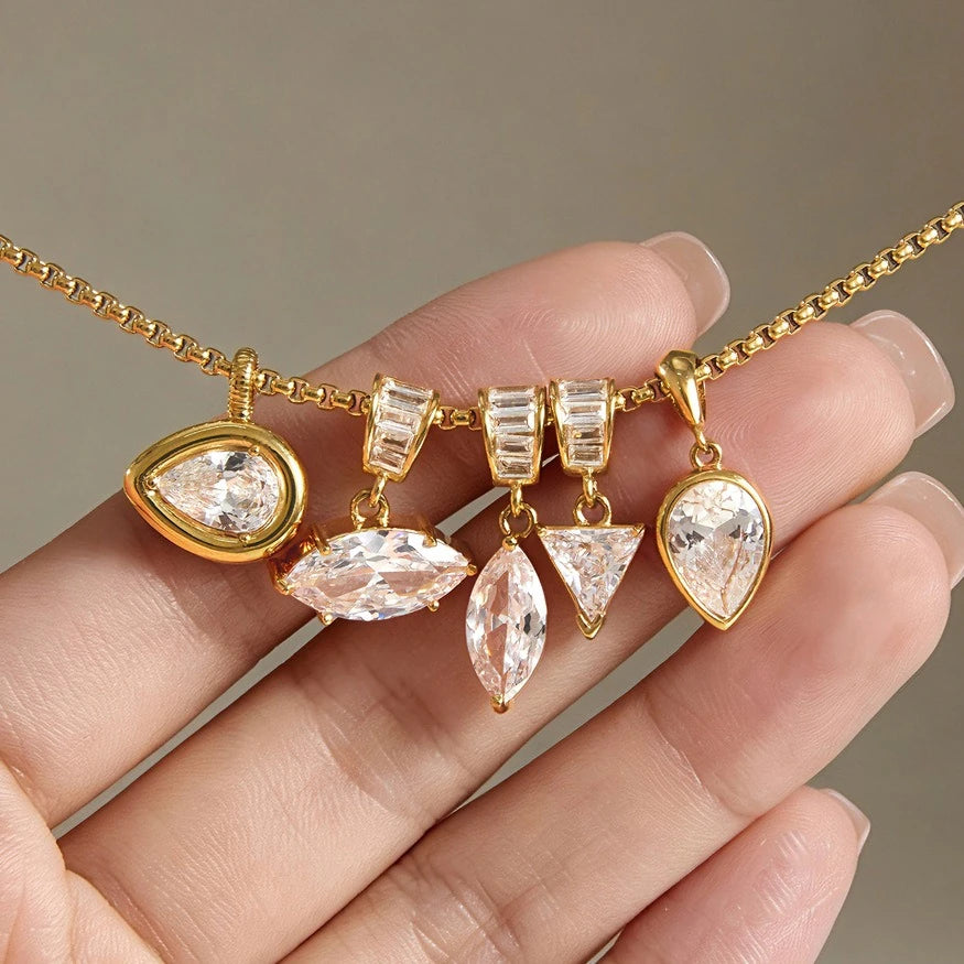 Close-up of five clear stone pendant shapes displayed on a chain