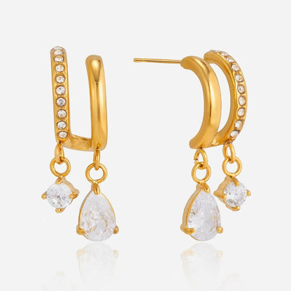 Double hoop drop earrings with round and teardrop clear stones on a white background