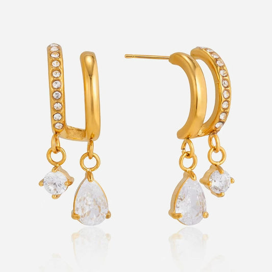 Double hoop drop earrings with round and teardrop clear stones on a white background