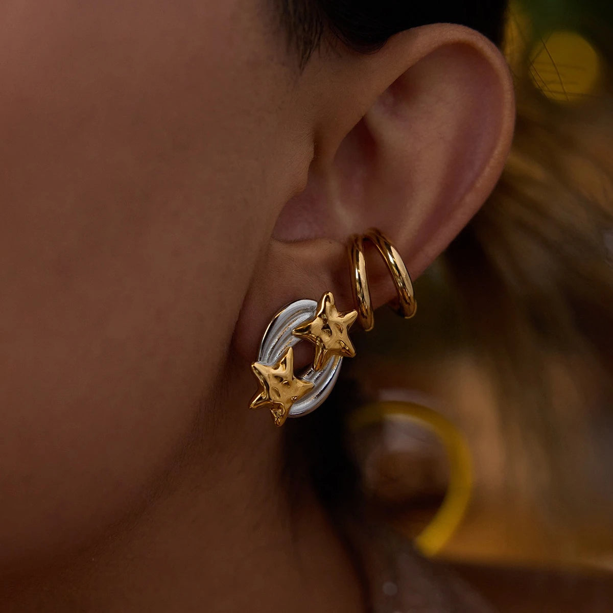 Double star earrings styled with a double hoop ear cuff