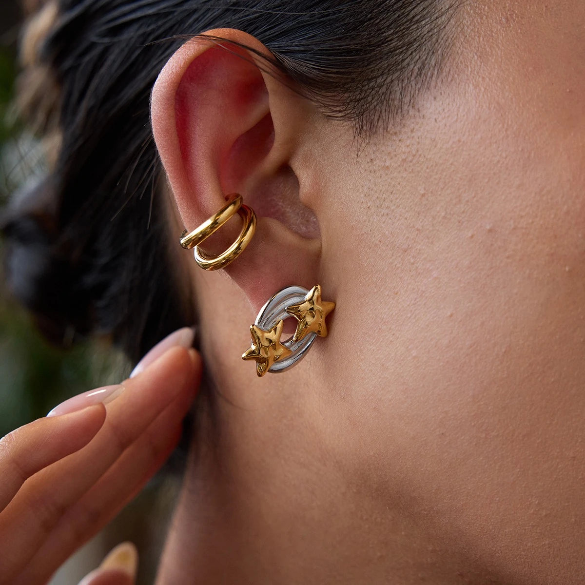 Close-up of double star earrings and a double hoop ear cuff