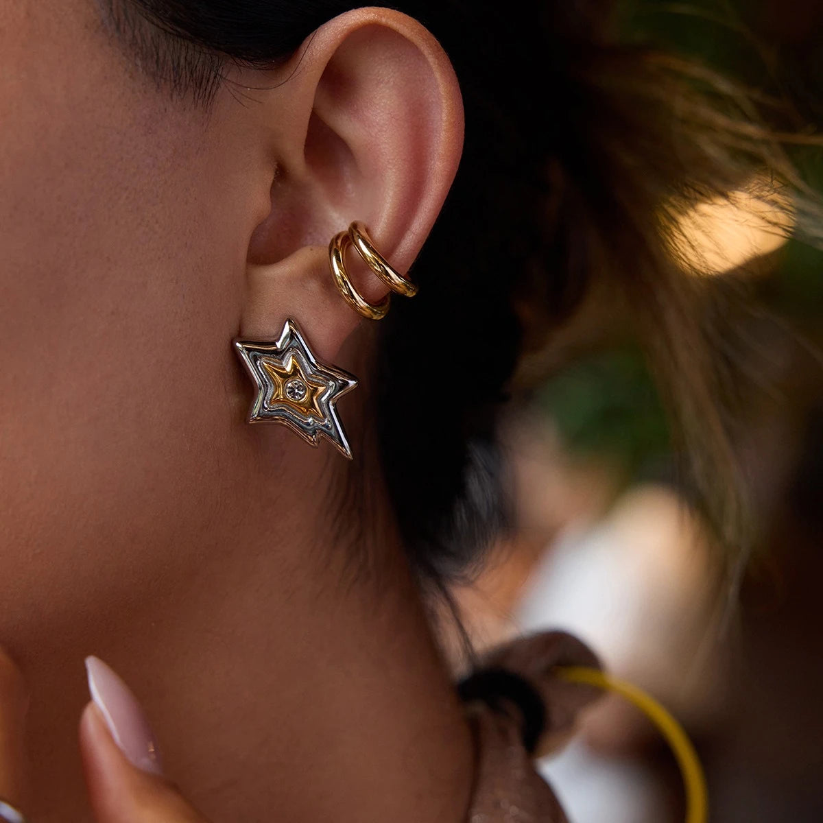 Layered star earrings styled with a double hoop ear cuff