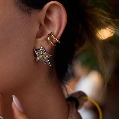 Layered star earrings styled with a double hoop ear cuff