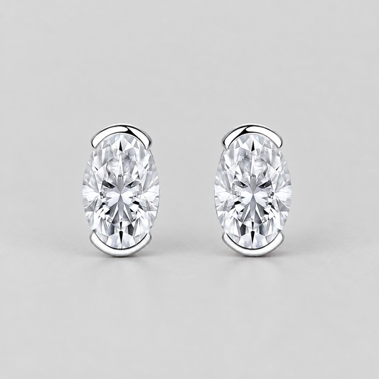 Half-Bezel Oval Moissanite Stud Earrings in 925 sterling silver.