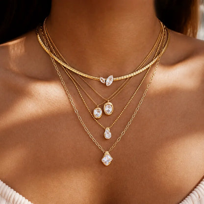 Layered pendant necklaces with clear geometric stones worn together