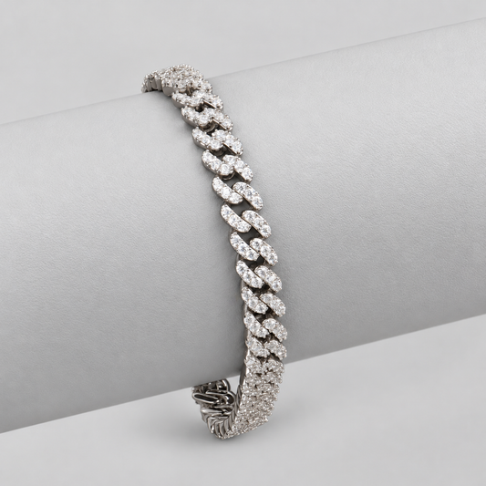 Silver-finish moissanite Cuban link bracelet draped over a light gray display.