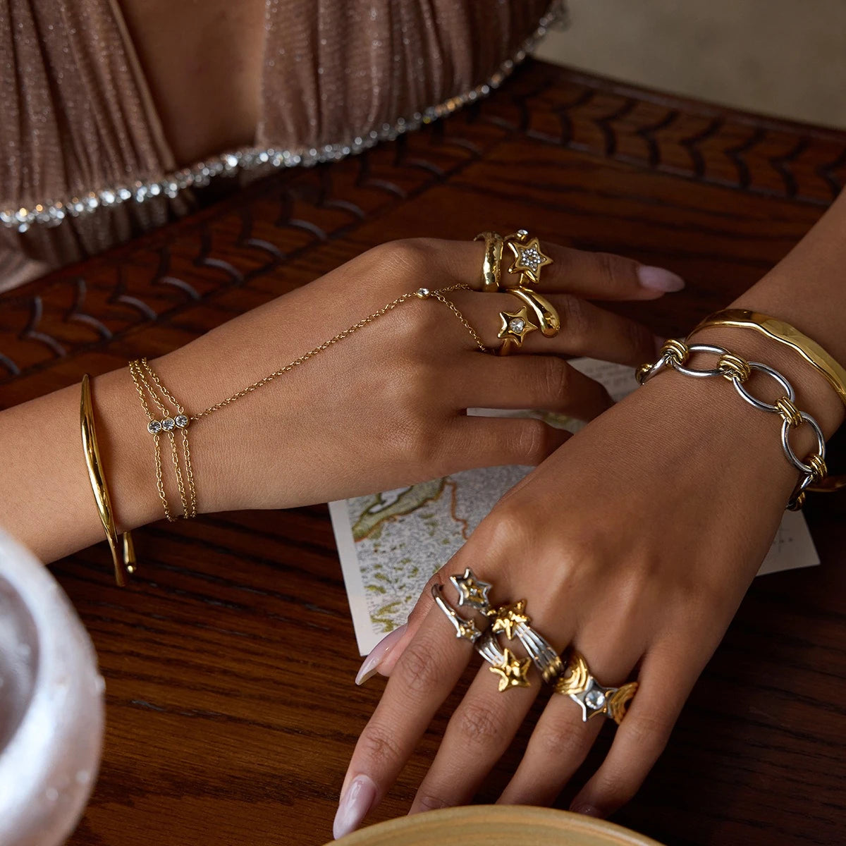 Star motif open ring collection styled with bracelets and hand jewelry
