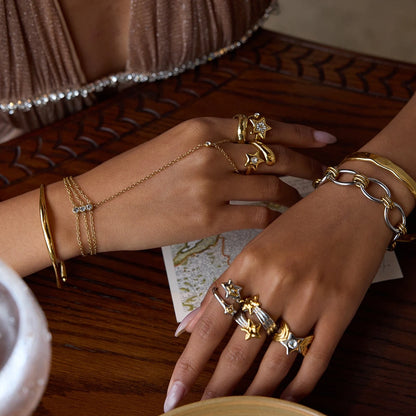 Star motif open ring collection styled with bracelets and hand jewelry
