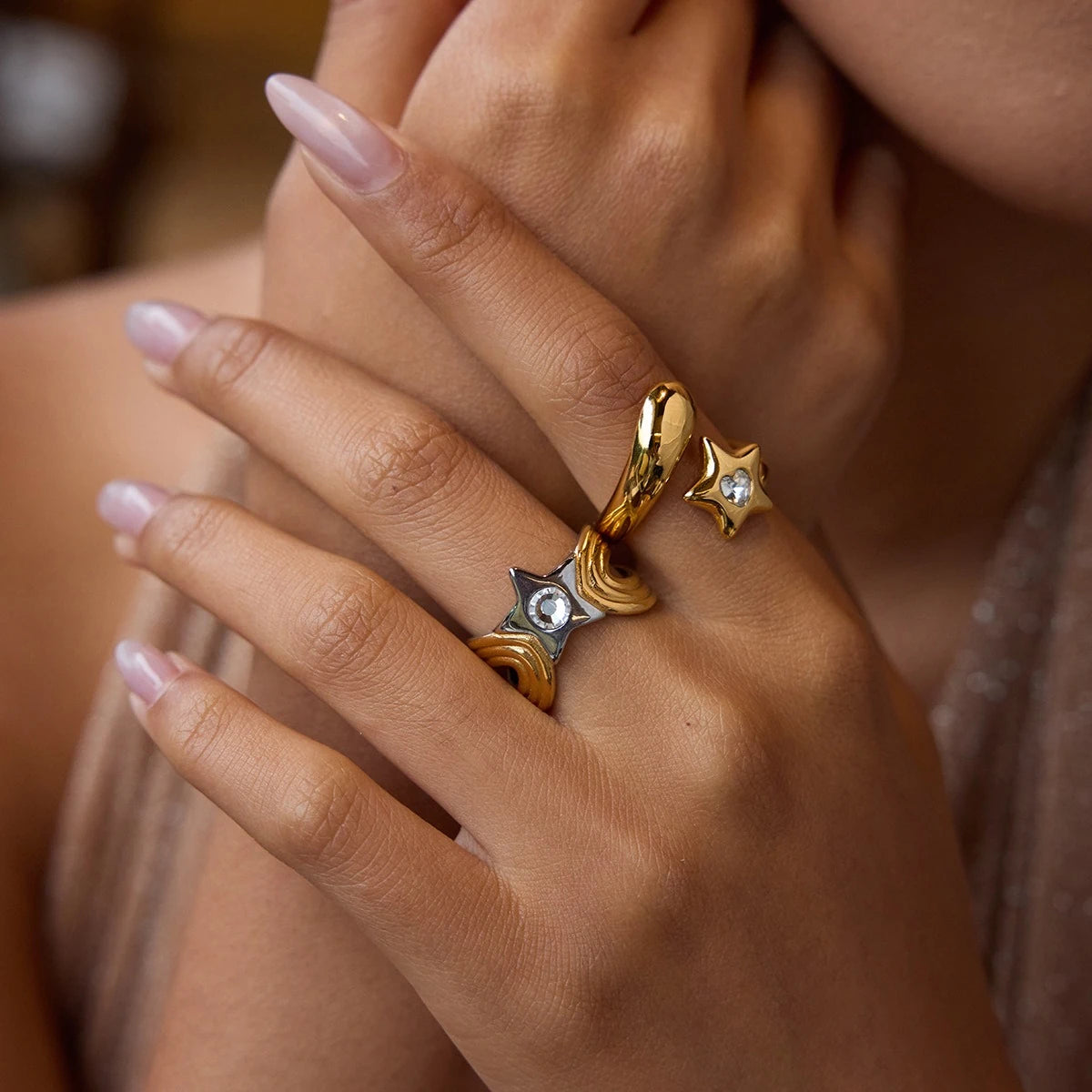 Close-up of star motif open rings styled on a hand