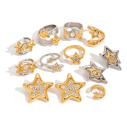 Assorted star motif rings and earrings arranged on a white background